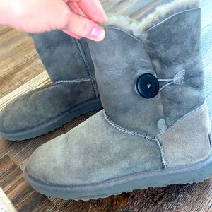 Grey UGG boots with button.